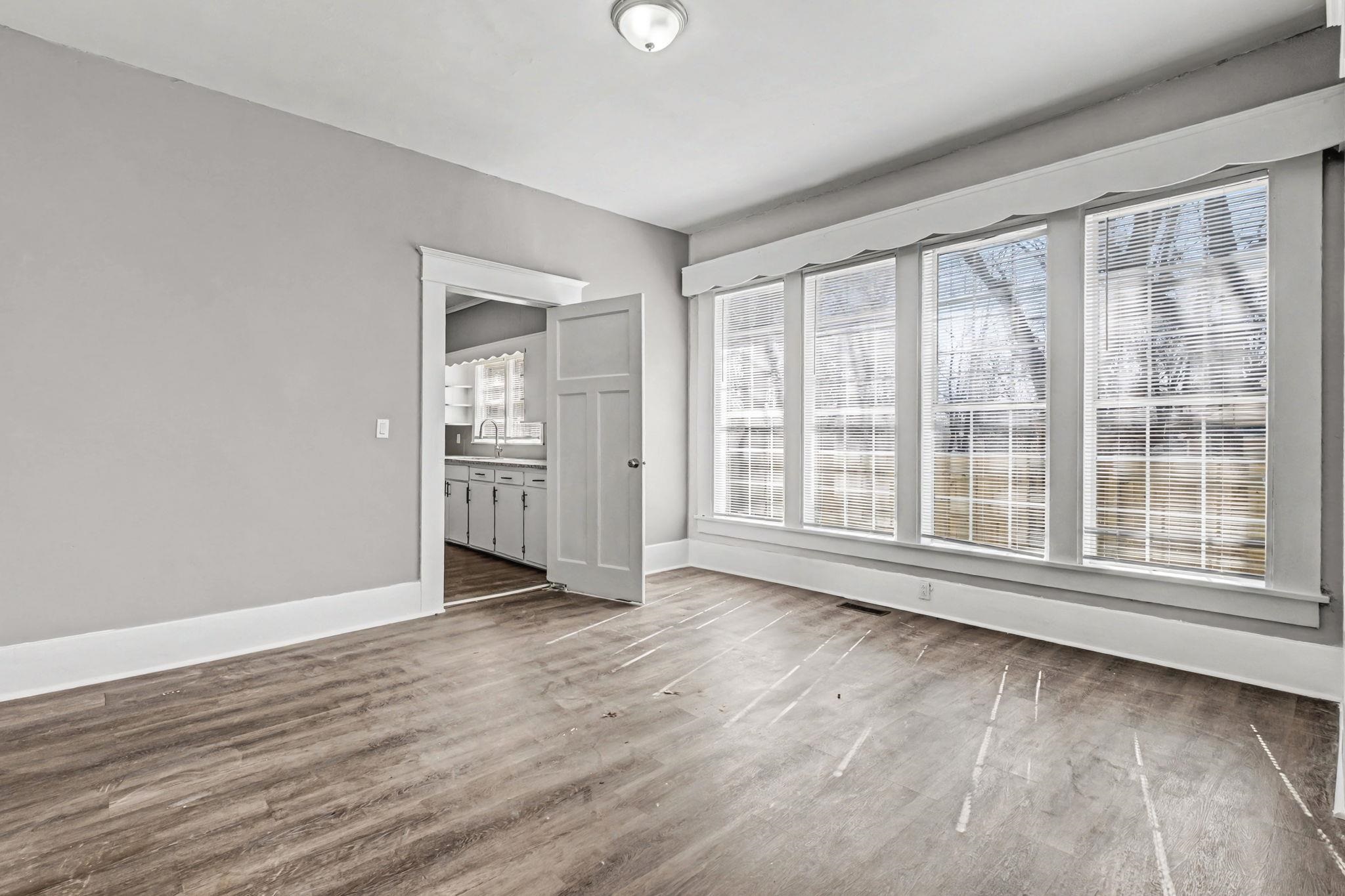 320 North High Street Covington, TN 38019 - Photo 26 of 32 a view of an empty room with wooden floor and a window