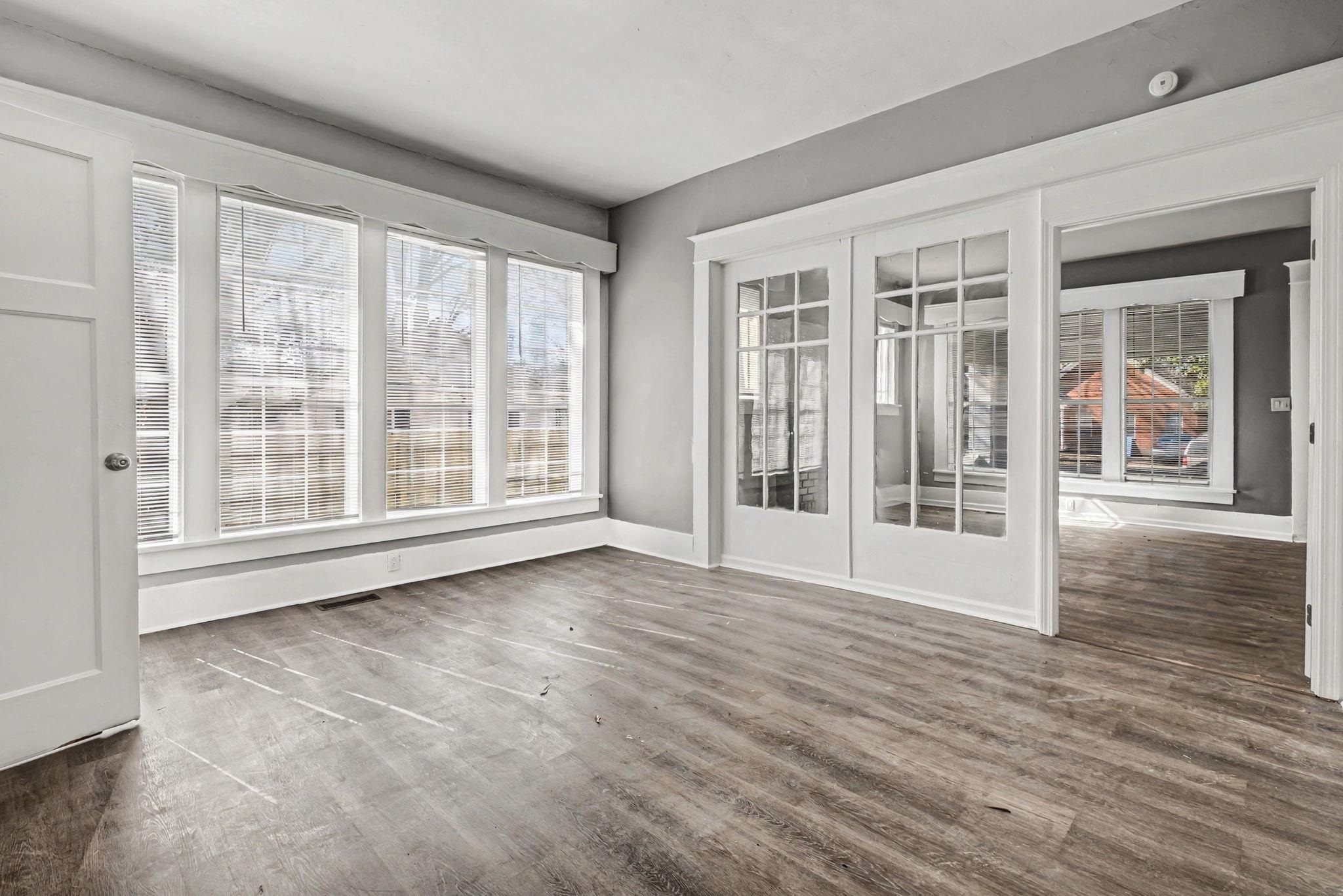 320 North High Street Covington, TN 38019 - Photo 7 of 32 a view of an empty room with wooden floor and a window