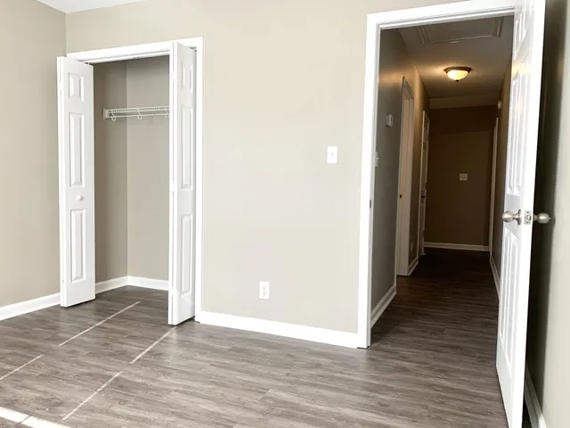 an empty room and closet with wooden floor