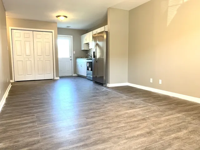 a view of a kitchen with wooden floor and electronic appliances
