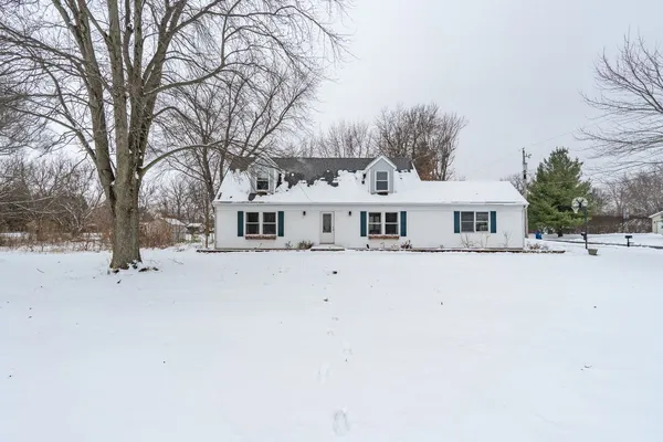 a front view of house with trees and trees