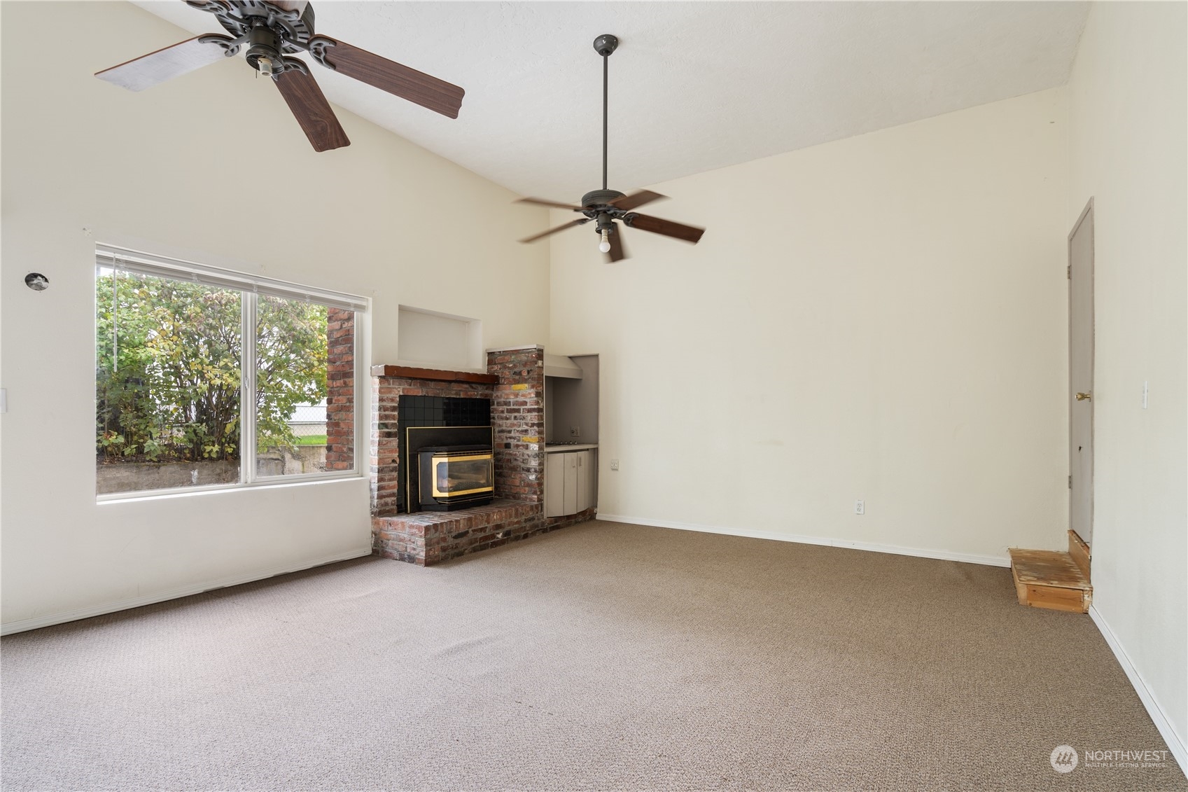 11632 24th Avenue South Seattle, WA 98168 - Photo 11 of 38 a view of empty room with fireplace and windows