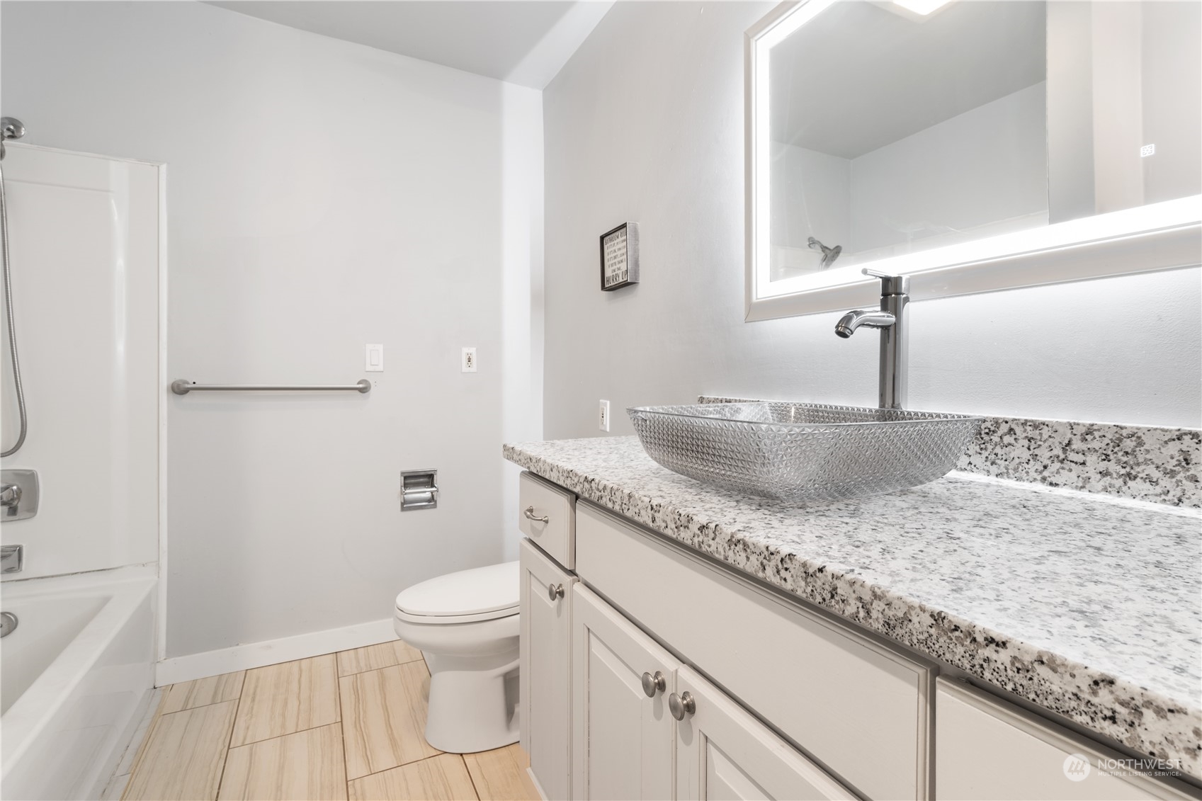 11632 24th Avenue South Seattle, WA 98168 - Photo 15 of 38 a bathroom with a granite countertop sink a toilet and a mirror