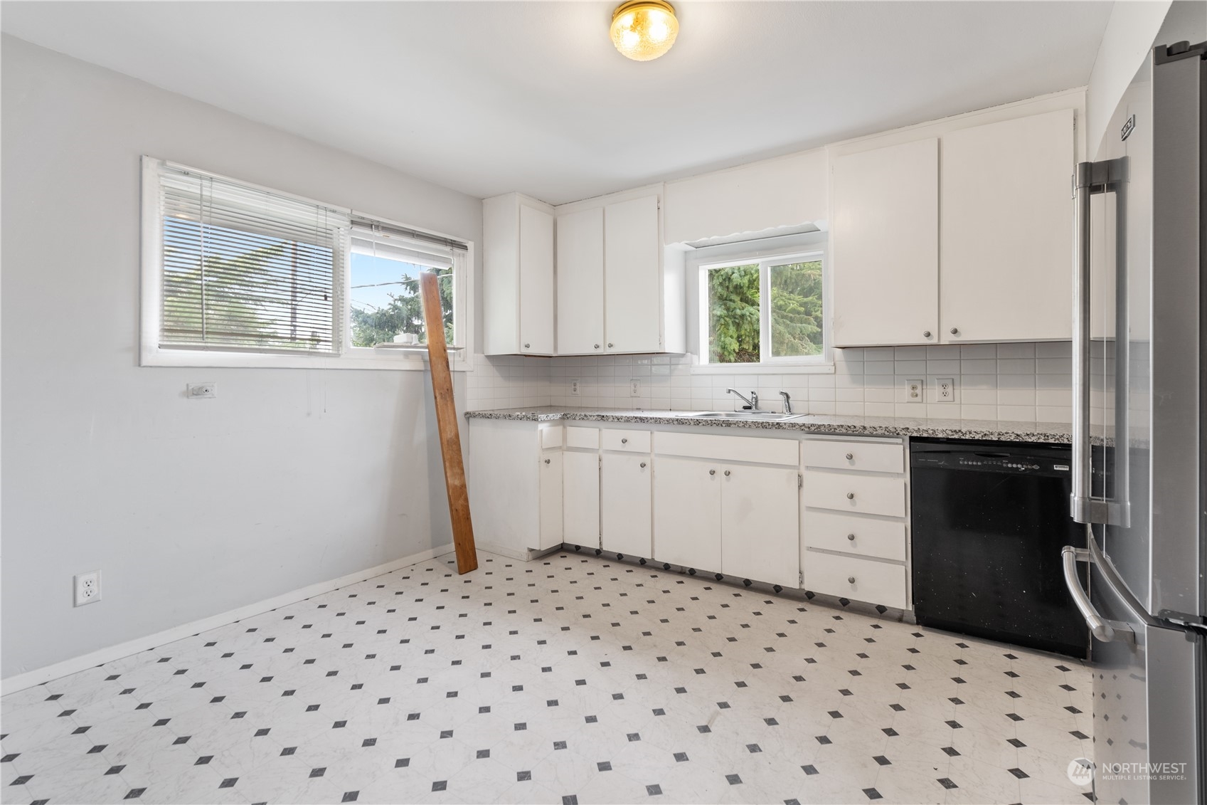 11632 24th Avenue South Seattle, WA 98168 - Photo 16 of 38 a kitchen with a sink window and cabinets