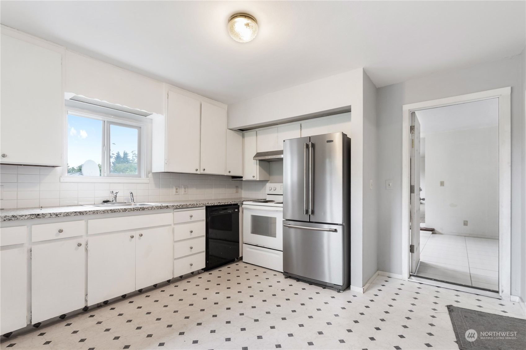 11632 24th Avenue South Seattle, WA 98168 - Photo 17 of 38 a kitchen with granite countertop a refrigerator and a sink