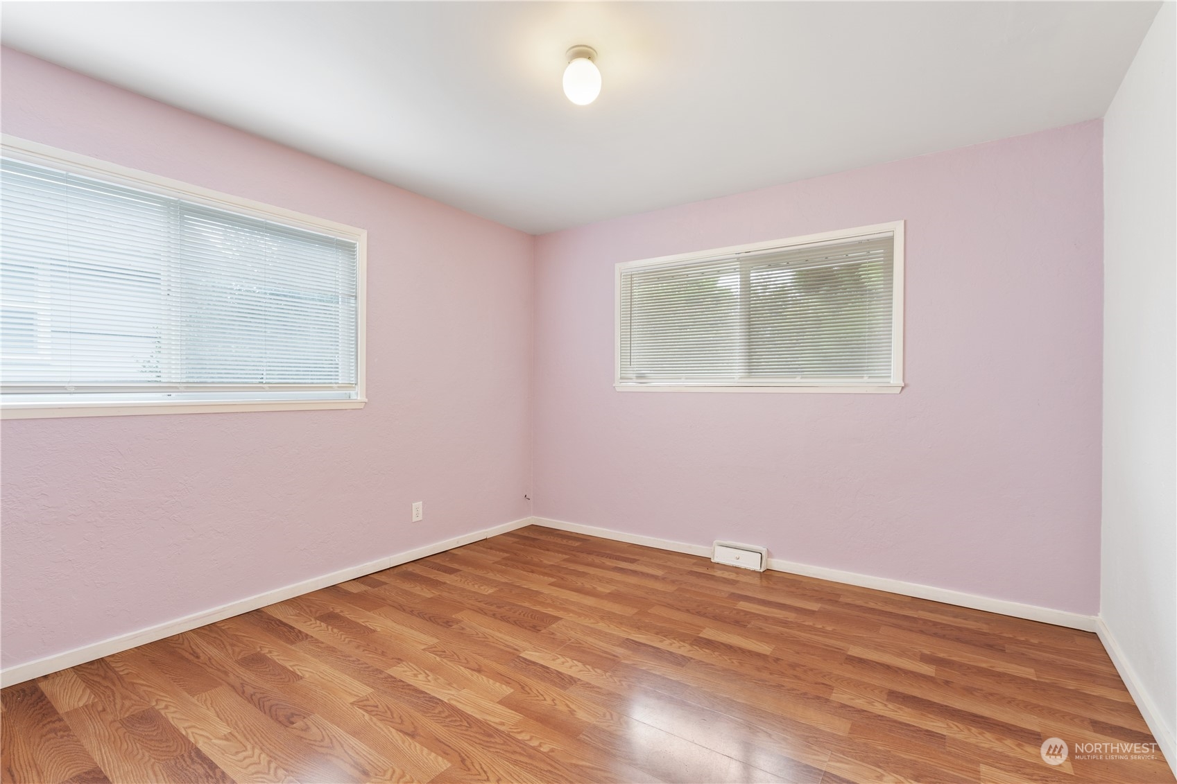 11632 24th Avenue South Seattle, WA 98168 - Photo 22 of 38 a view of an empty room with wooden floor and a window