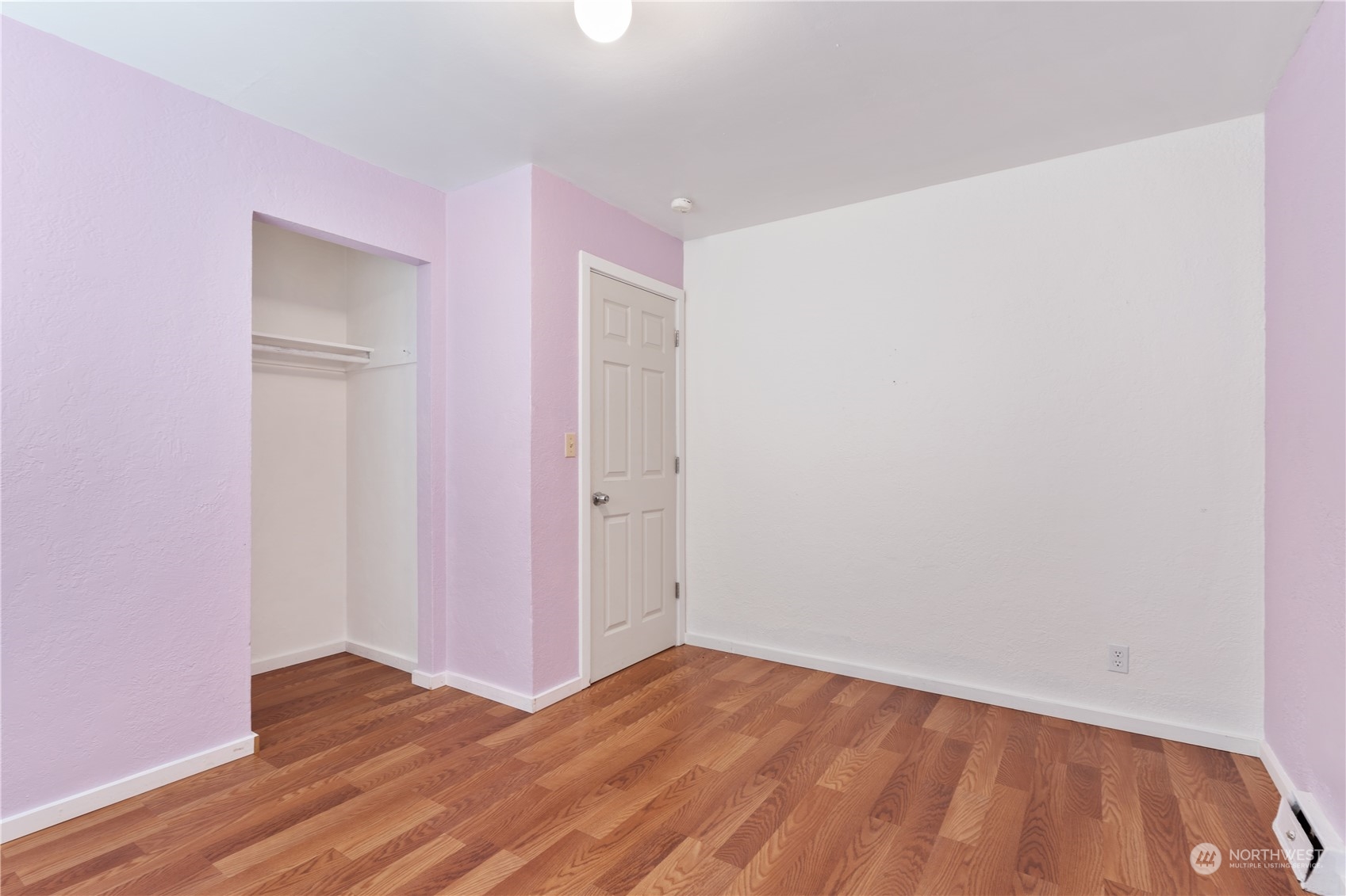 11632 24th Avenue South Seattle, WA 98168 - Photo 26 of 38 a view of an empty room with wooden floor and closet