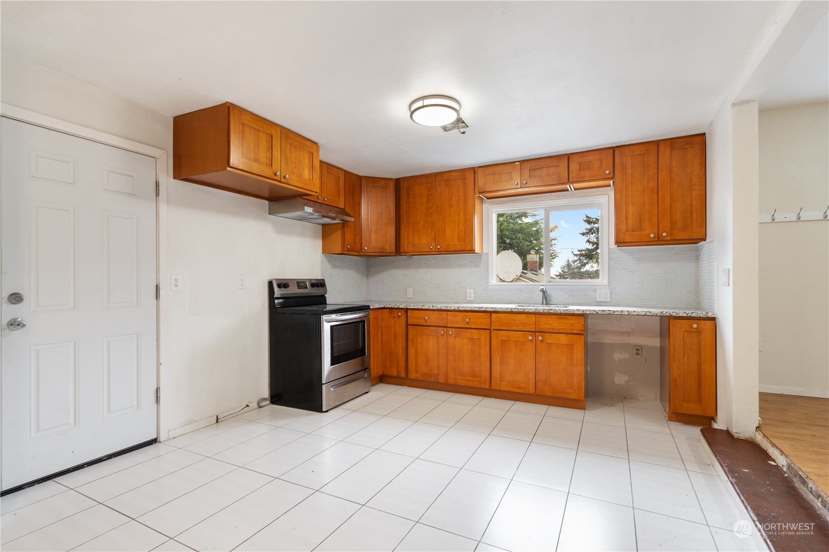11632 24th Avenue South Seattle, WA 98168 - Photo 4 of 38 a kitchen with stainless steel appliances granite countertop a sink and cabinets