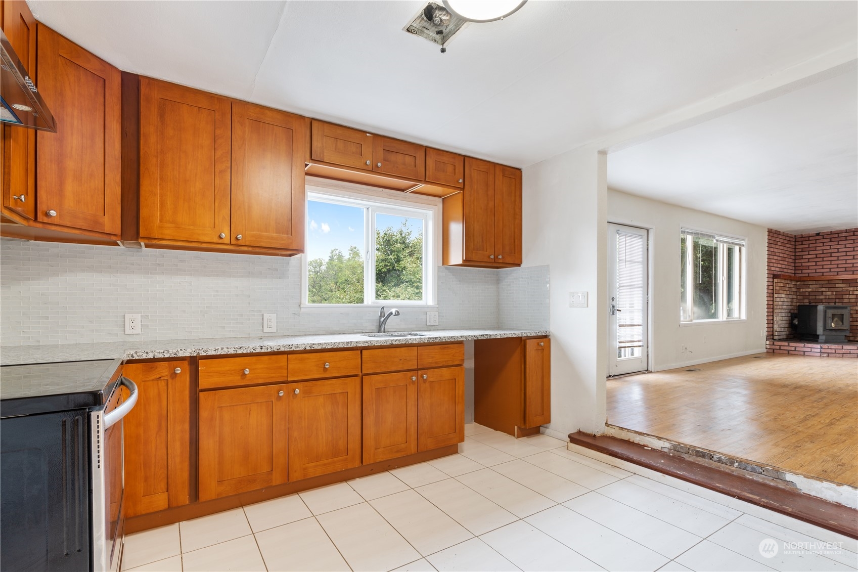 11632 24th Avenue South Seattle, WA 98168 - Photo 5 of 38 a large white kitchen with granite countertop a sink