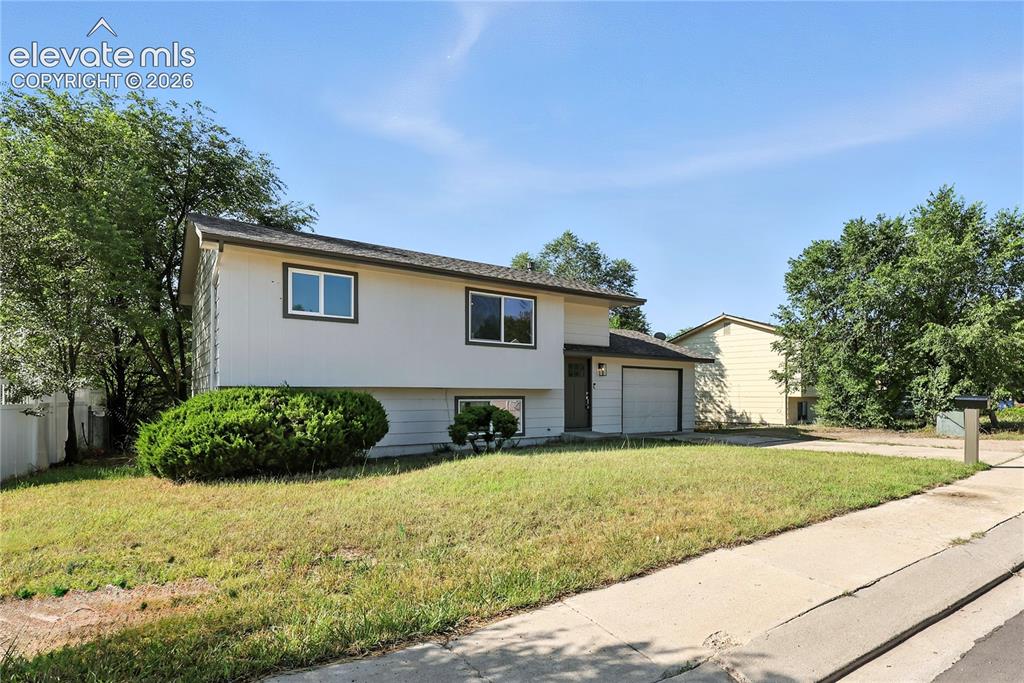 7033 Sequoyah Way Colorado Springs, CO 80915 - Photo 2 of 20 a front view of a house with a yard
