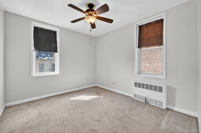 a view of empty room with ceiling fan