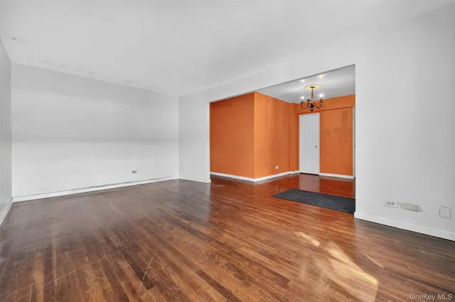 an empty room with wooden floor and closet