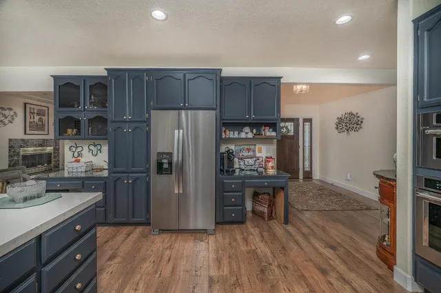 a kitchen with stainless steel appliances granite countertop a stove a sink and a refrigerator
