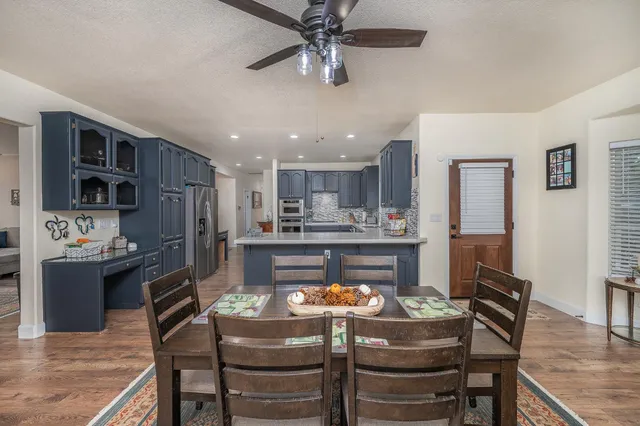 a living room with granite countertop furniture a rug and a chandelier