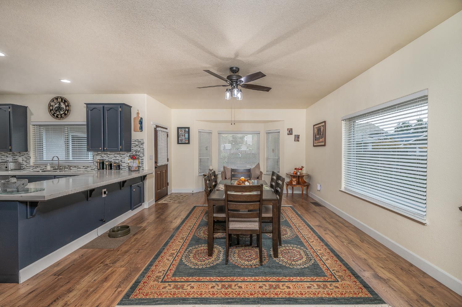1850 Hammond Drive Turlock, CA 95382 - Photo 20 of 57 a living room with granite countertop furniture a rug and a chandelier