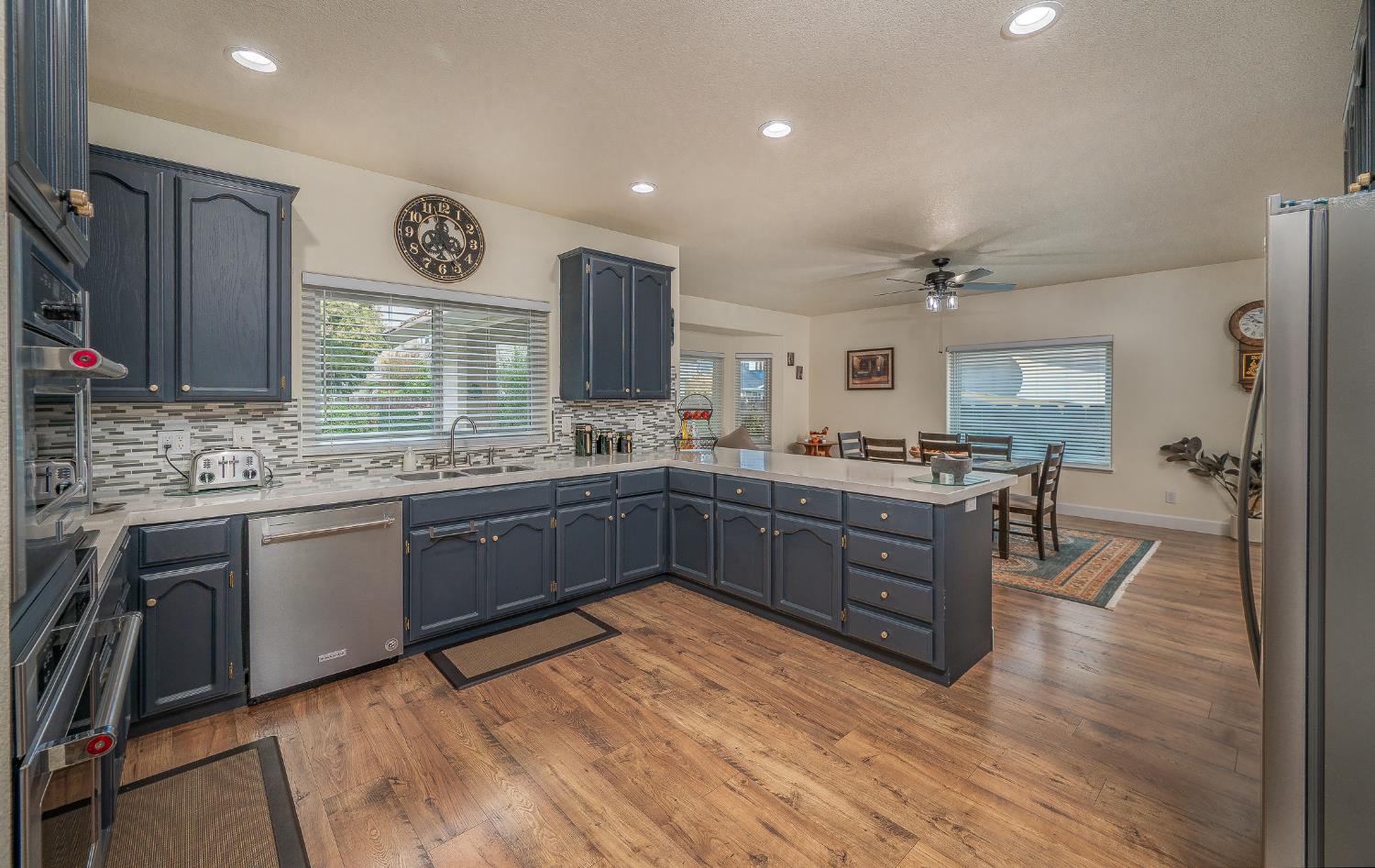 1850 Hammond Drive Turlock, CA 95382 - Photo 22 of 57 a kitchen with stainless steel appliances kitchen island granite countertop a stove refrigerator and cabinets