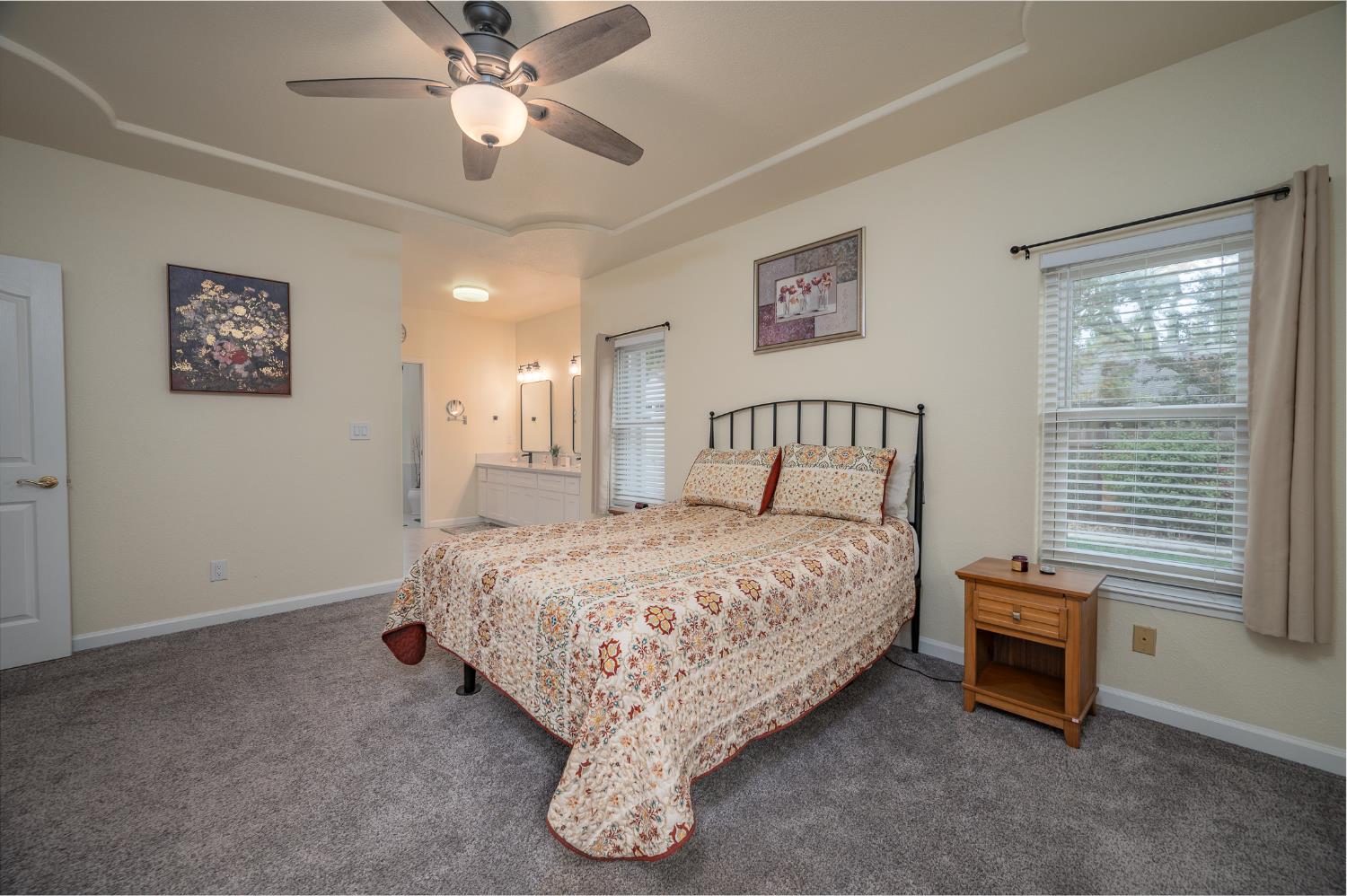 1850 Hammond Drive Turlock, CA 95382 - Photo 24 of 57 a bedroom with a bed and a chandelier