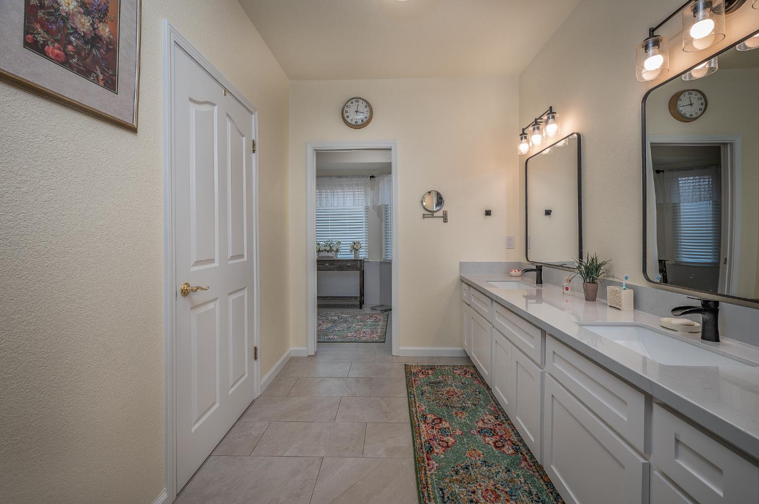 1850 Hammond Drive Turlock, CA 95382 - Photo 29 of 57 a bathroom with a double vanity sink and a mirror