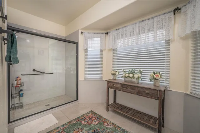 a spacious bathroom with a double vanity sink and a mirror