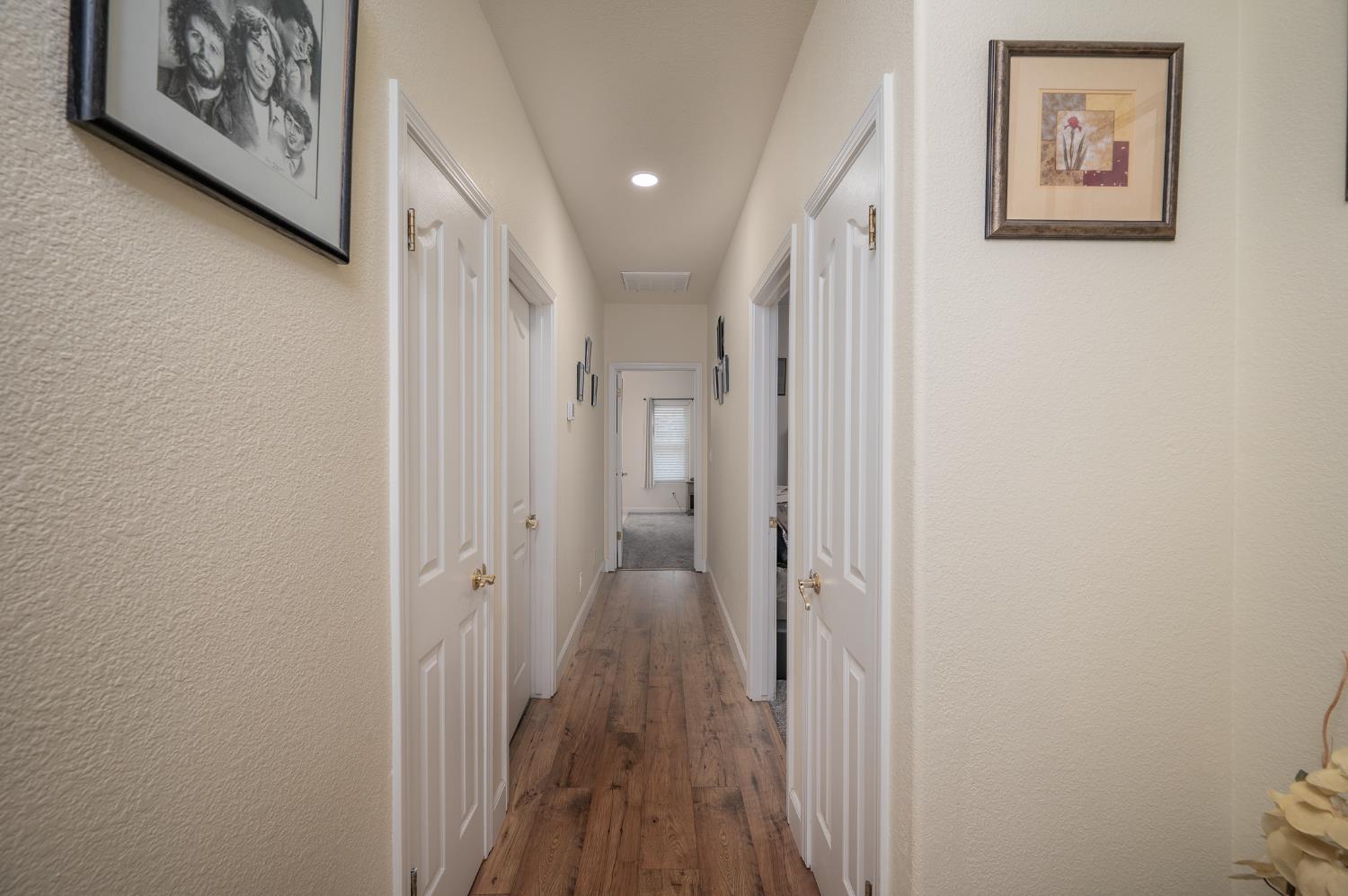 1850 Hammond Drive Turlock, CA 95382 - Photo 38 of 57 a view of a hallway with wooden floor and closet