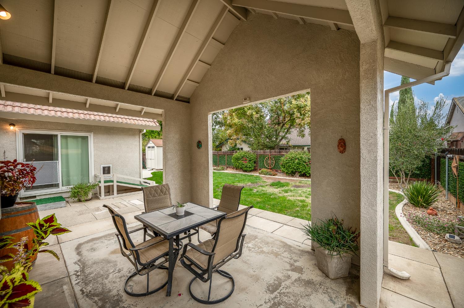 1850 Hammond Drive Turlock, CA 95382 - Photo 44 of 57 a view of a patio with table and chairs potted plants with wooden floor
