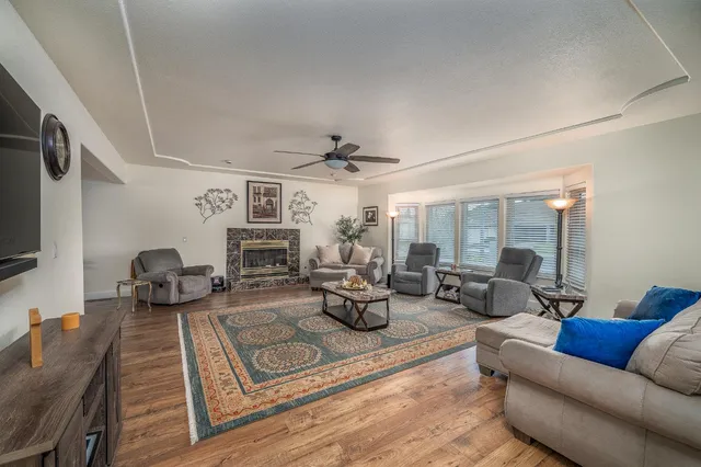 a living room with furniture large window and flat screen tv