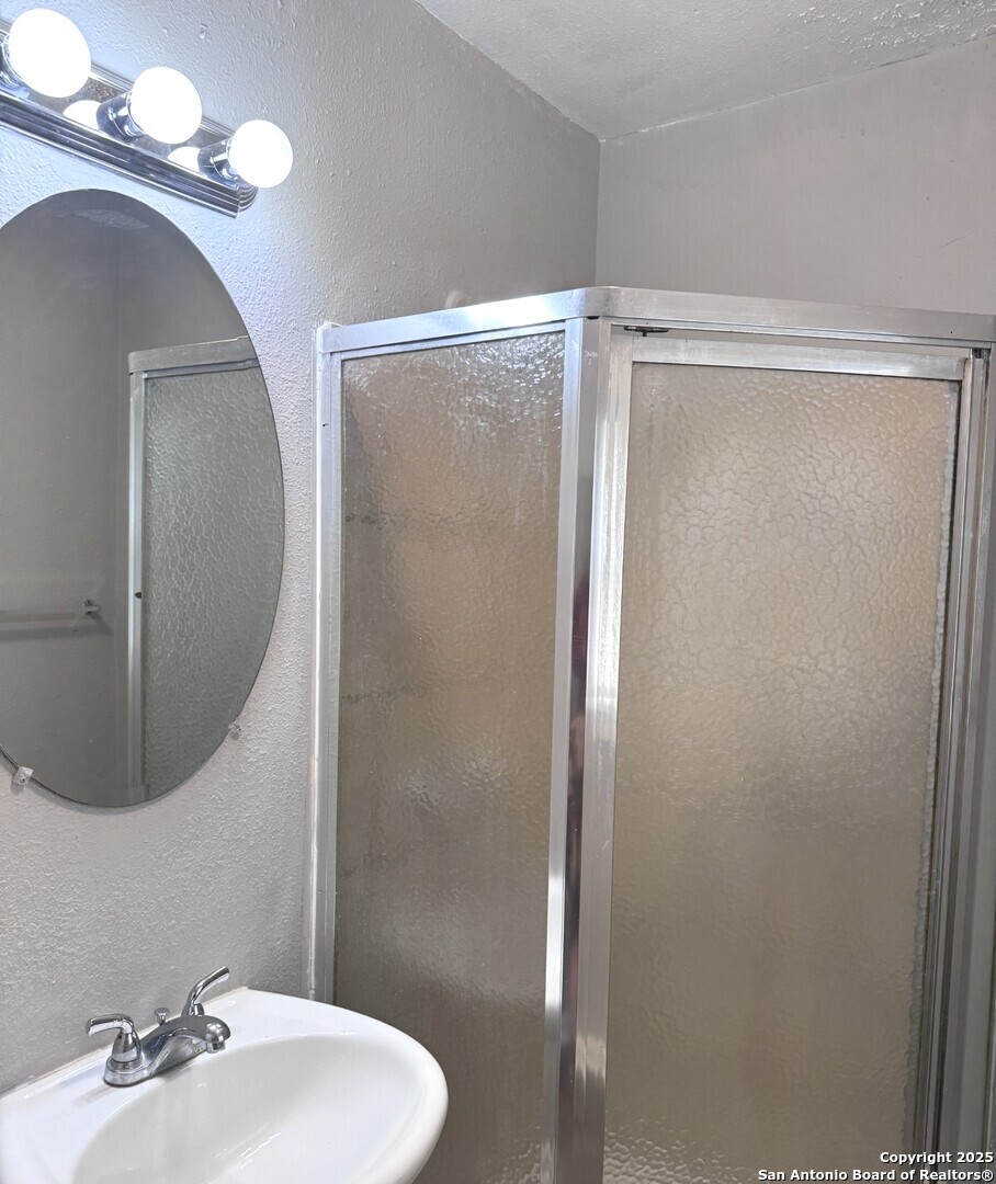 403 Terrell Avenue, Unit 2 San Antonio, TX 78214 - Photo 11 of 12 a bathroom with a sink and mirror