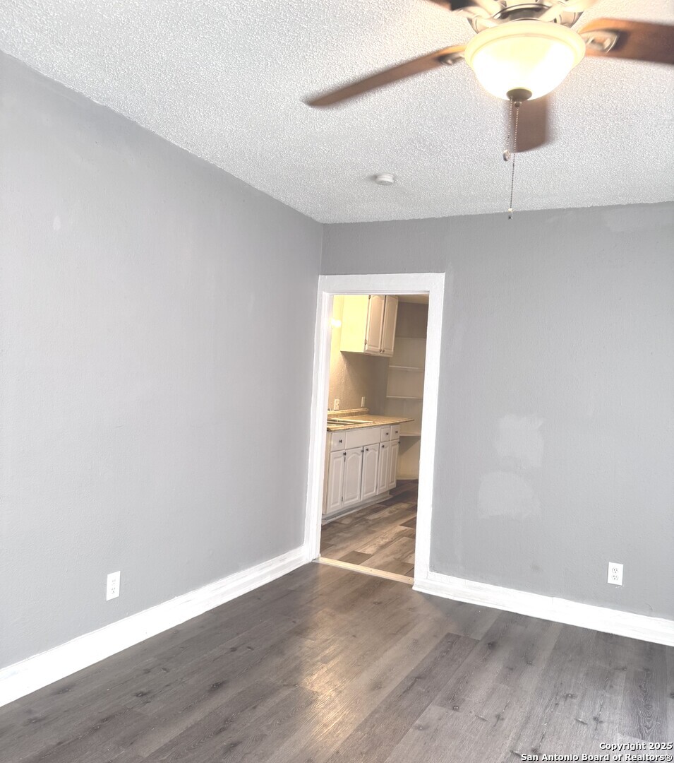 403 Terrell Avenue, Unit 2 San Antonio, TX 78214 - Photo 12 of 12 a view of an empty room with wooden floor and a window