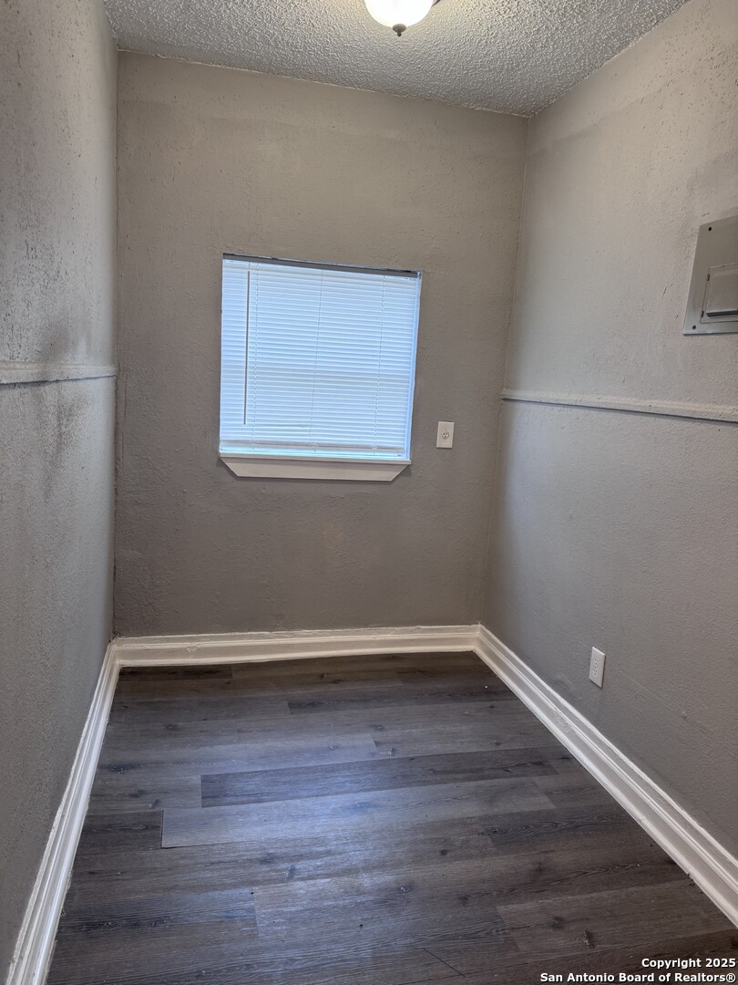 403 Terrell Avenue, Unit 2 San Antonio, TX 78214 - Photo 9 of 12 a view of an empty room with wooden floor and a window