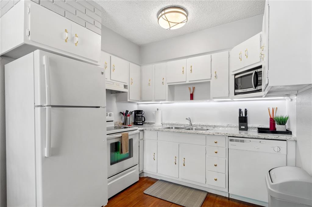 5596 100th Way North St. Petersburg, FL 33708 - Photo 14 of 67 a kitchen with stainless steel appliances a refrigerator sink and cabinets