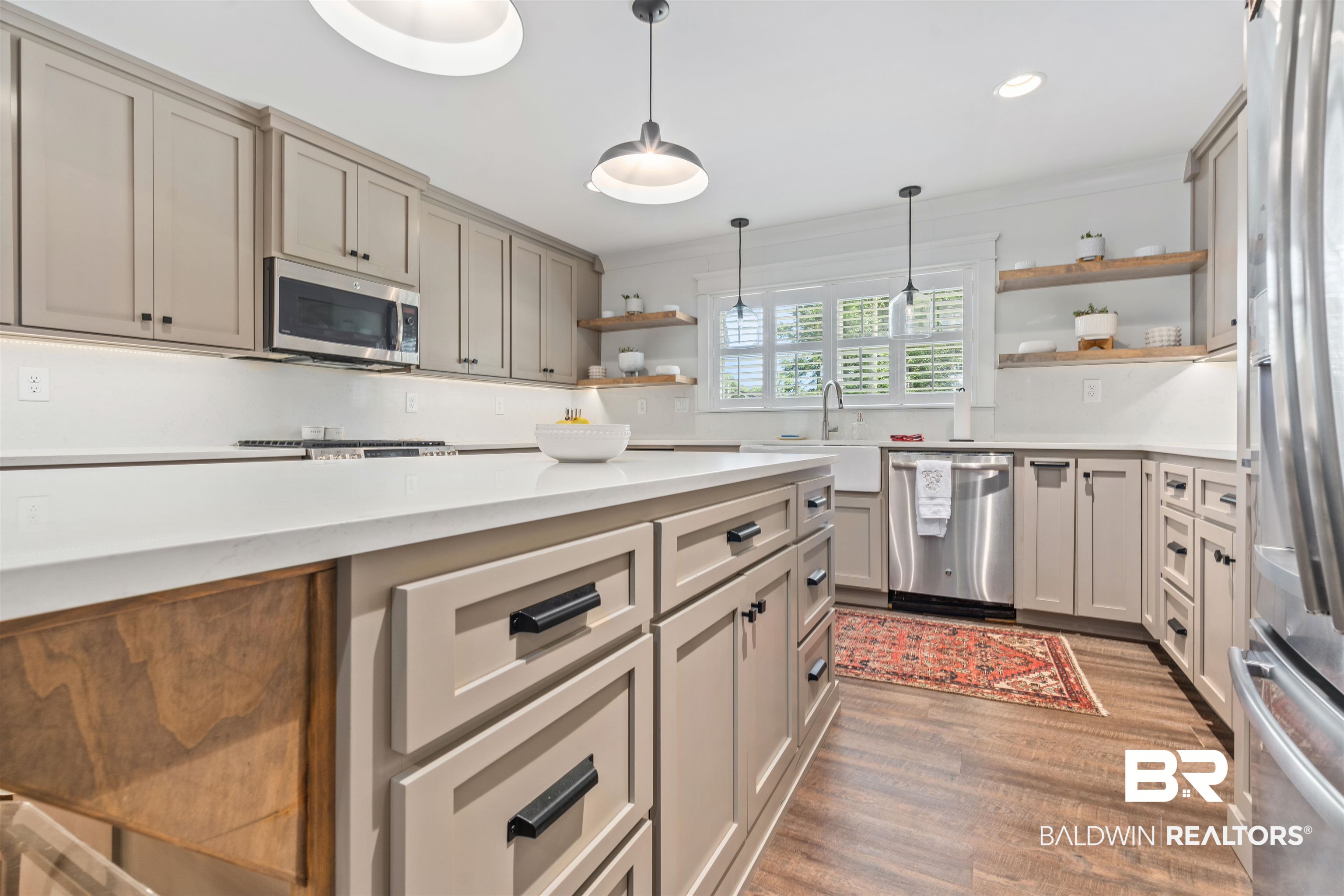 3808 Claridge Road North Mobile, AL 36608 - Photo 10 of 43 Kitchen with light hardwood / wood-style flooring, appliances with stainless steel finishes, decorative backsplash, pendant lighting, and gray cabinetry