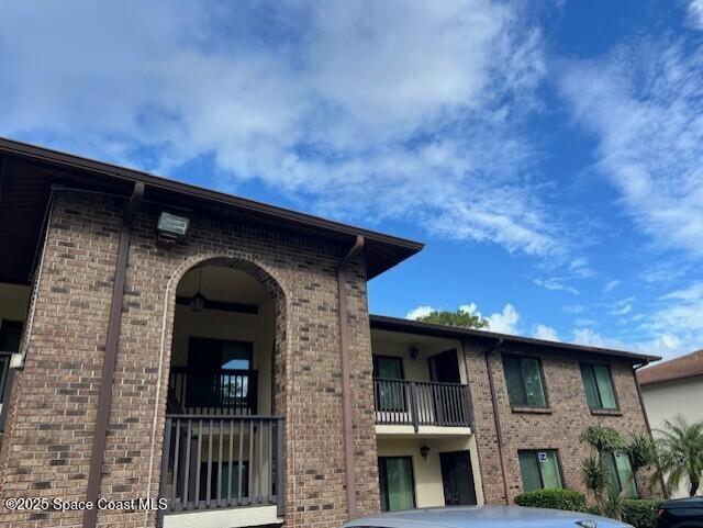 1515 Huntington Lane, Unit 128 Rockledge, FL 32955 - Photo 2 of 7 a front view of a house with plants