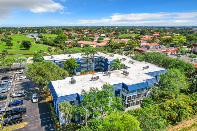 an aerial view of a house with garden space and outdoor seating