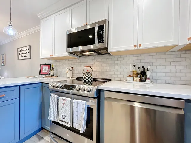 a kitchen with stainless steel appliances granite countertop a sink stove and microwave