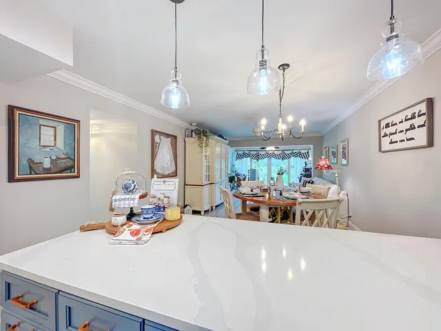 a living room with dining table and chairs