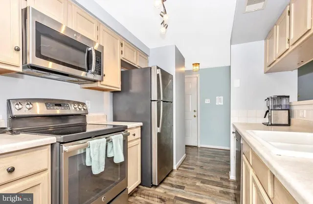 a kitchen with stainless steel appliances granite countertop a refrigerator stove and microwave