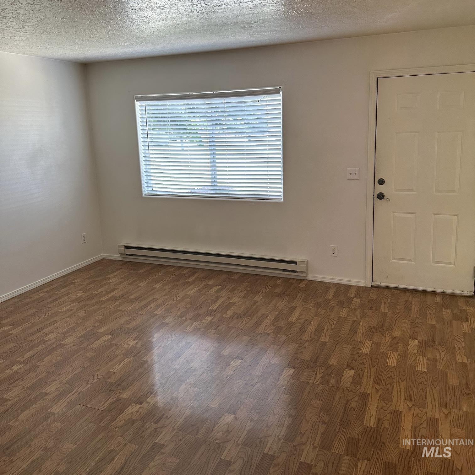 2140 Elizabeth Boulevard Twin Falls, ID 83301 - Photo 13 of 18 Entryway with dark wood-style floors, a baseboard heating unit, and a textured ceiling