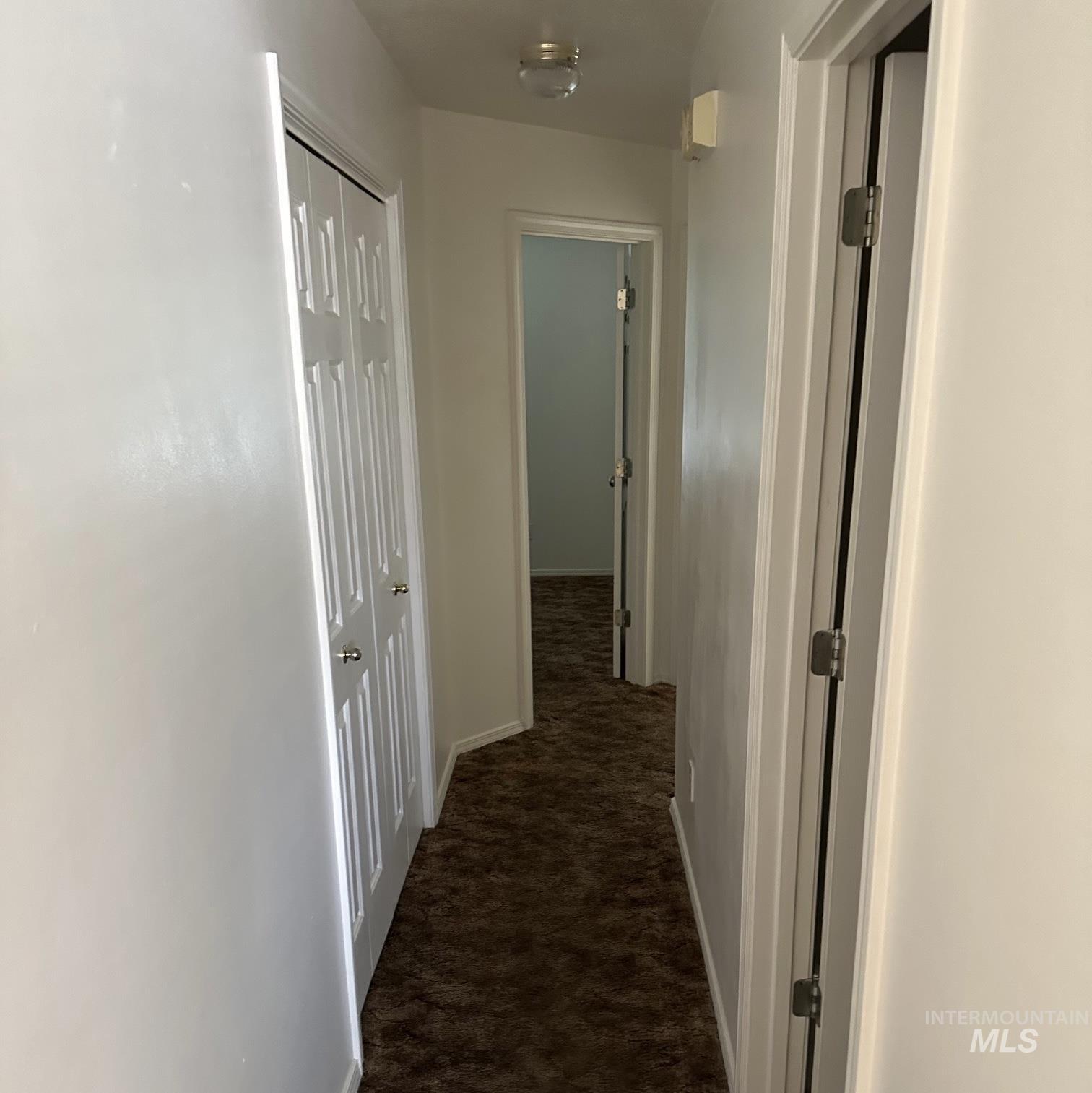 2140 Elizabeth Boulevard Twin Falls, ID 83301 - Photo 14 of 18 Hallway with dark carpet and baseboards