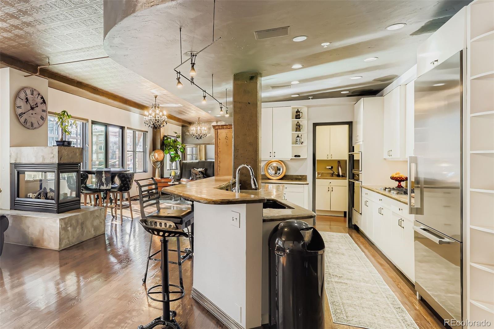 1735 19th Street, Unit 5B Denver, CO 80202 - Photo 11 of 50 a kitchen with counter top space a sink cabinets and appliances
