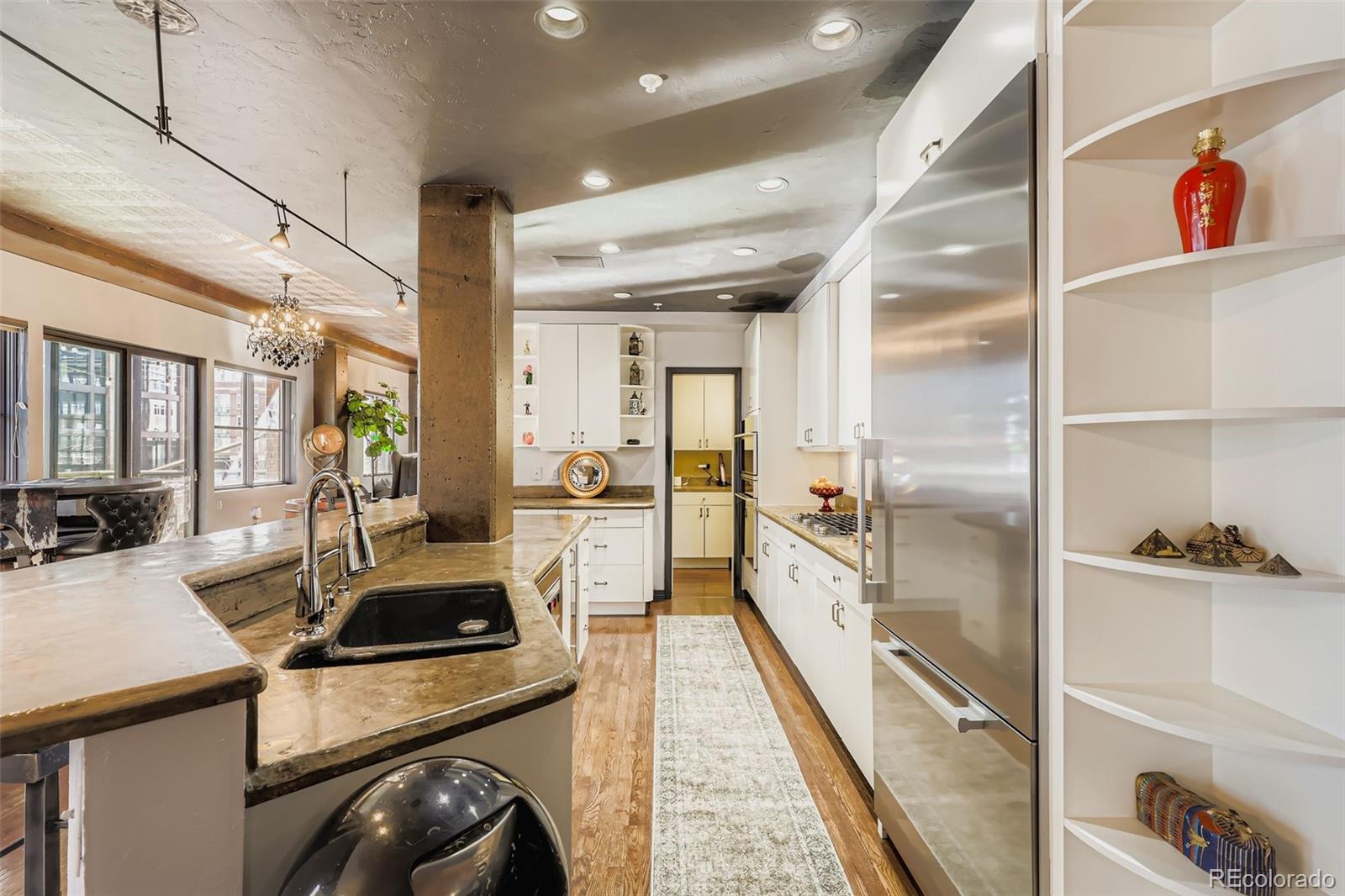 1735 19th Street, Unit 5B Denver, CO 80202 - Photo 12 of 50 a kitchen with sink stove and refrigerator