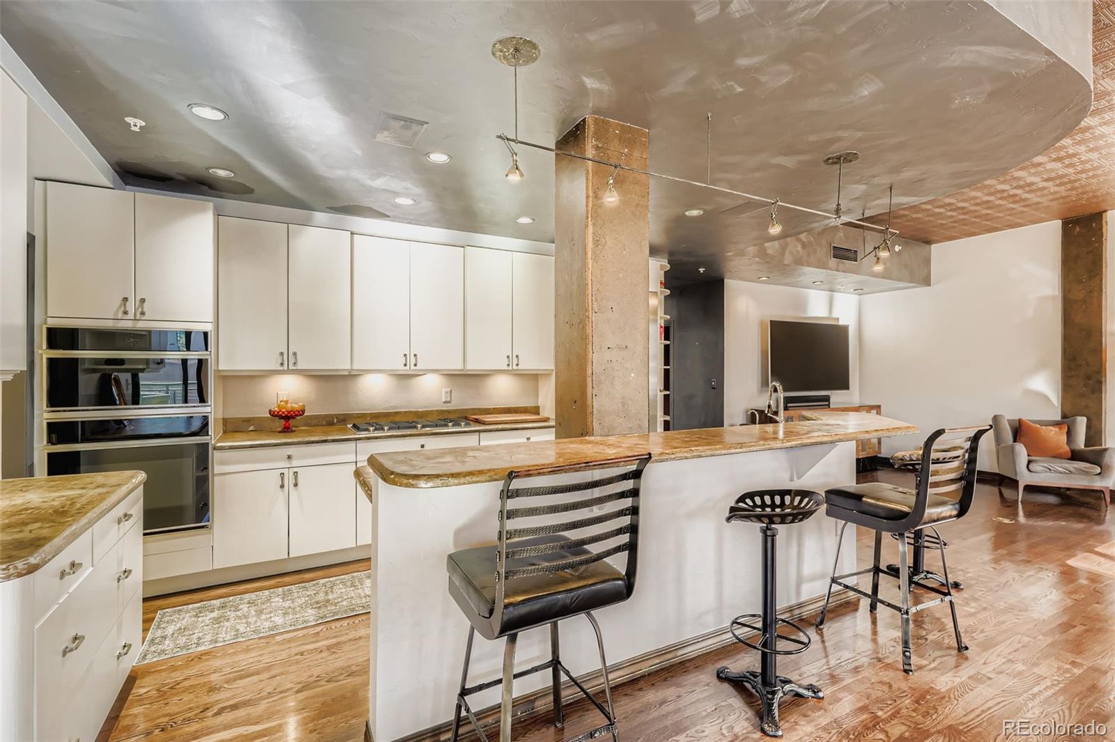 1735 19th Street, Unit 5B Denver, CO 80202 - Photo 13 of 50 a kitchen with a stove a sink and a refrigerator