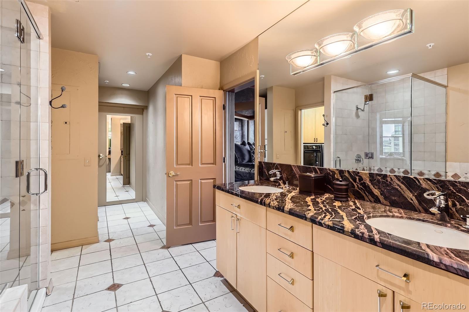 1735 19th Street, Unit 5B Denver, CO 80202 - Photo 22 of 50 a bathroom with a double vanity sink and a mirror