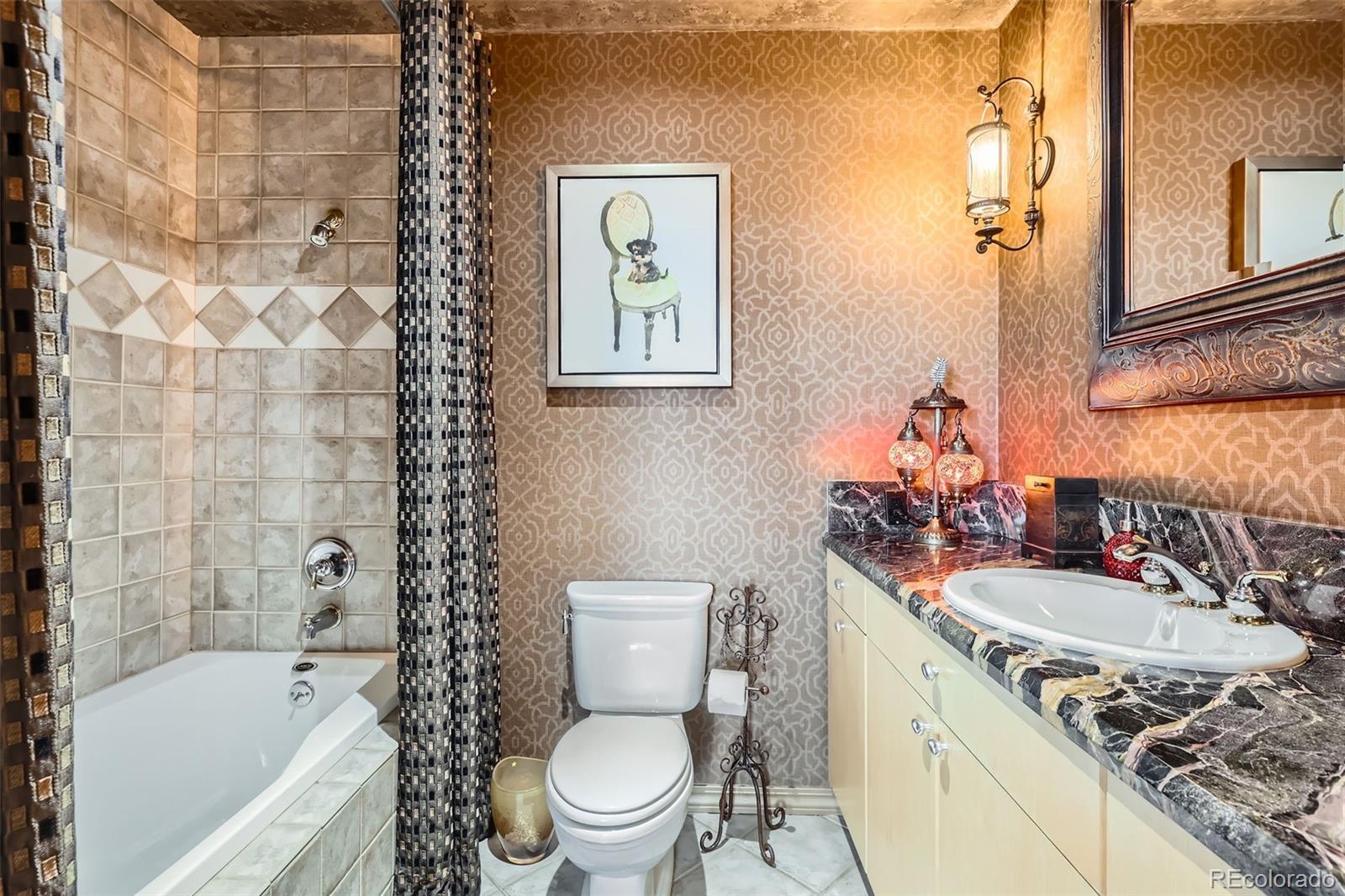 1735 19th Street, Unit 5B Denver, CO 80202 - Photo 28 of 50 a bathroom with a granite countertop toilet a sink a mirror a bathtub and shower