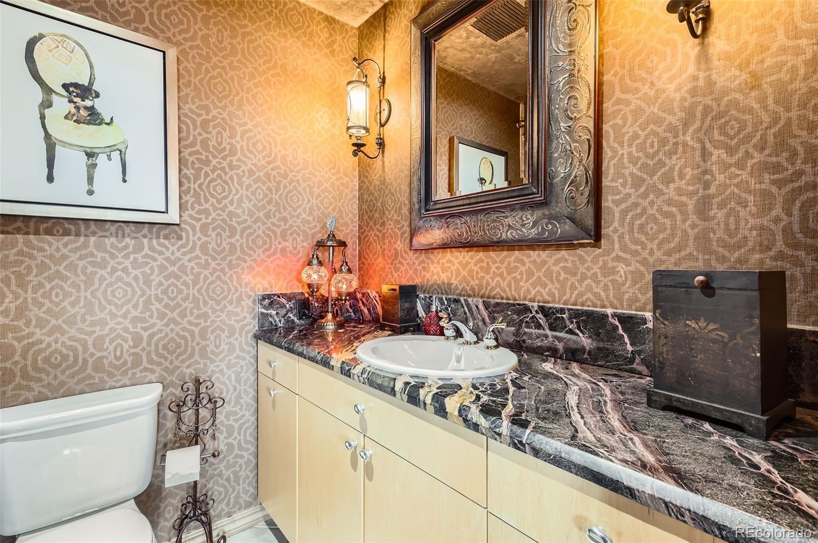 1735 19th Street, Unit 5B Denver, CO 80202 - Photo 29 of 50 a bathroom with a granite countertop sink mirror vanity and toilet