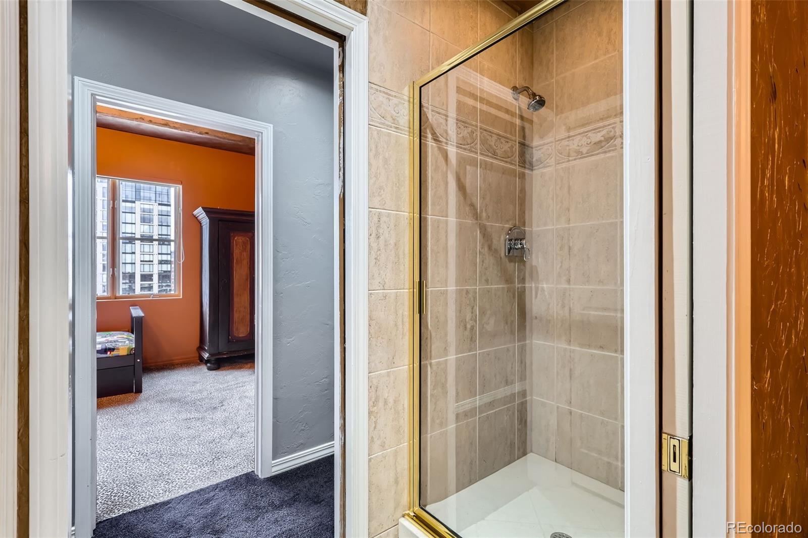 1735 19th Street, Unit 5B Denver, CO 80202 - Photo 33 of 50 a bathroom with a shower and a toilet