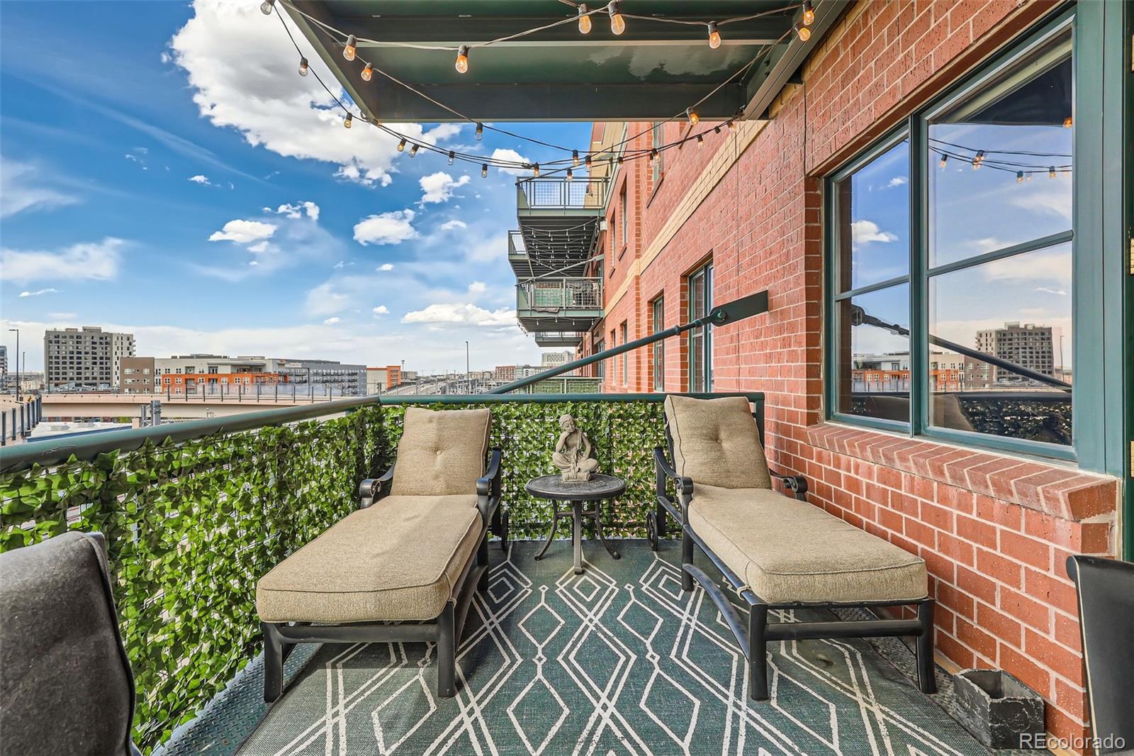 1735 19th Street, Unit 5B Denver, CO 80202 - Photo 38 of 50 a balcony with table and chairs