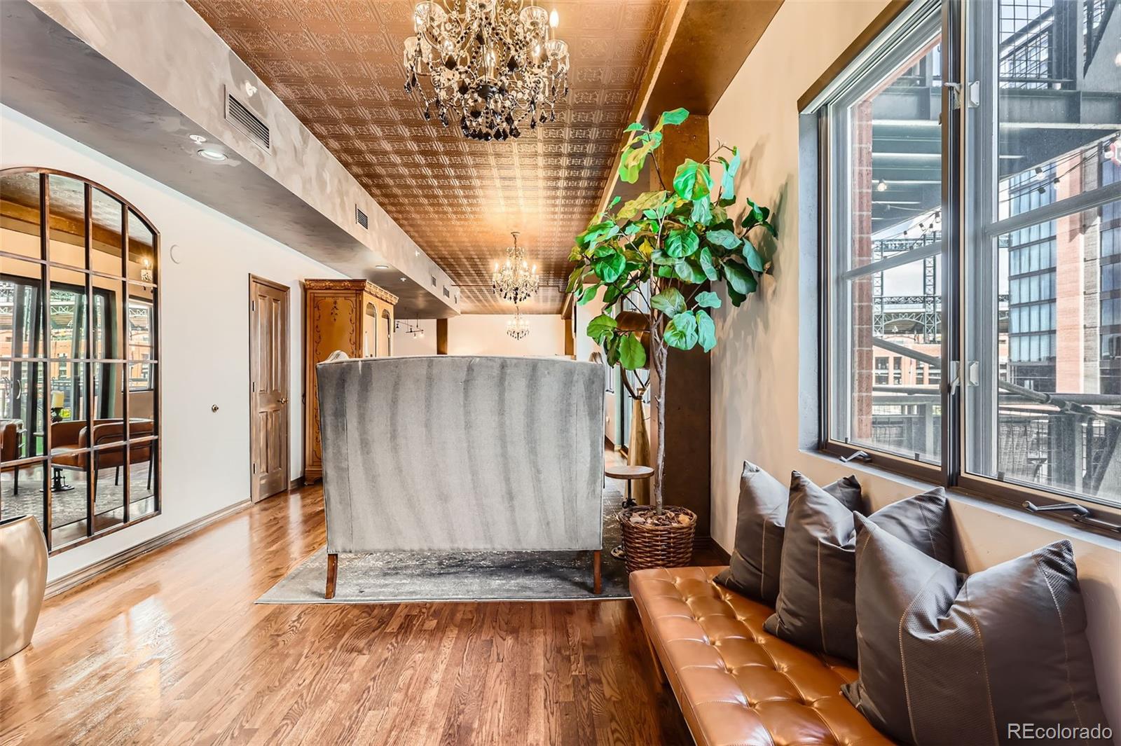 1735 19th Street, Unit 5B Denver, CO 80202 - Photo 4 of 50 a living room with furniture and a potted plant