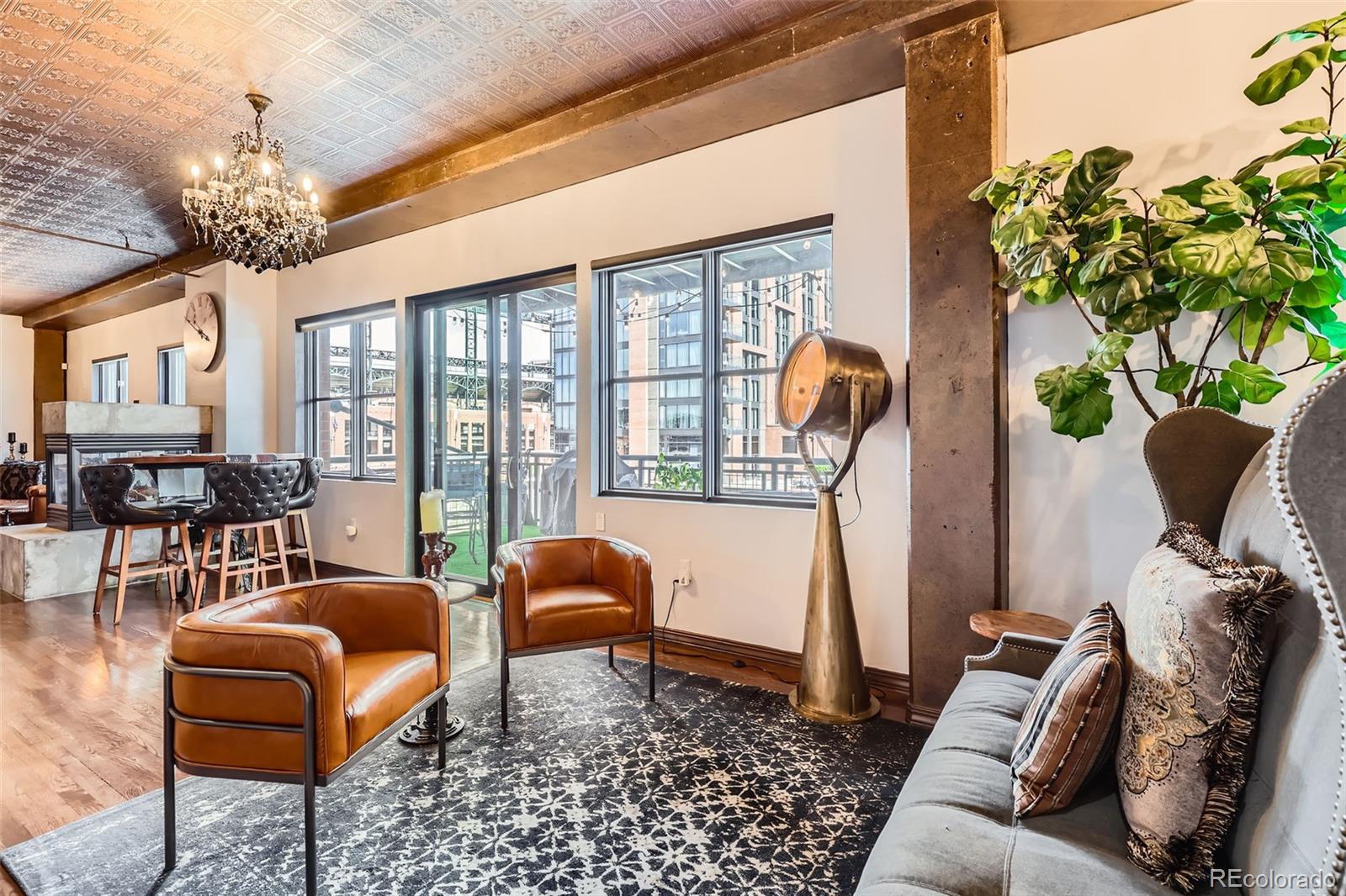 1735 19th Street, Unit 5B Denver, CO 80202 - Photo 5 of 50 a living room with furniture a chandelier and a chandelier