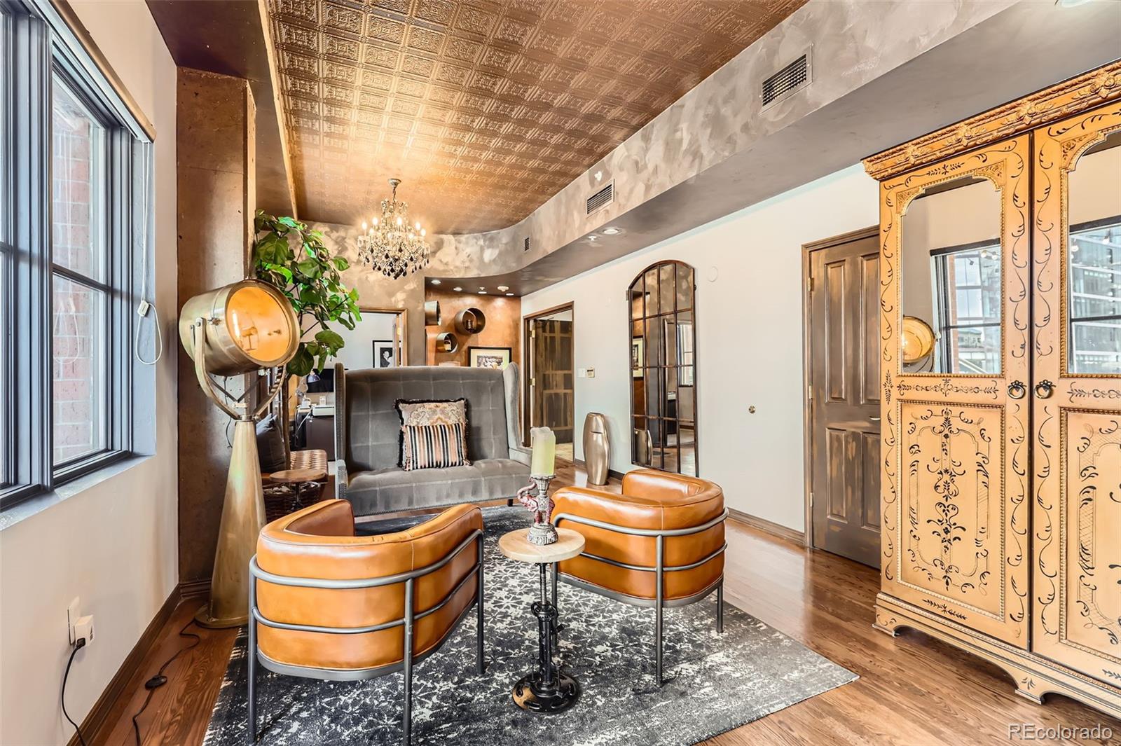 1735 19th Street, Unit 5B Denver, CO 80202 - Photo 6 of 50 a room with wooden furniture and large windows