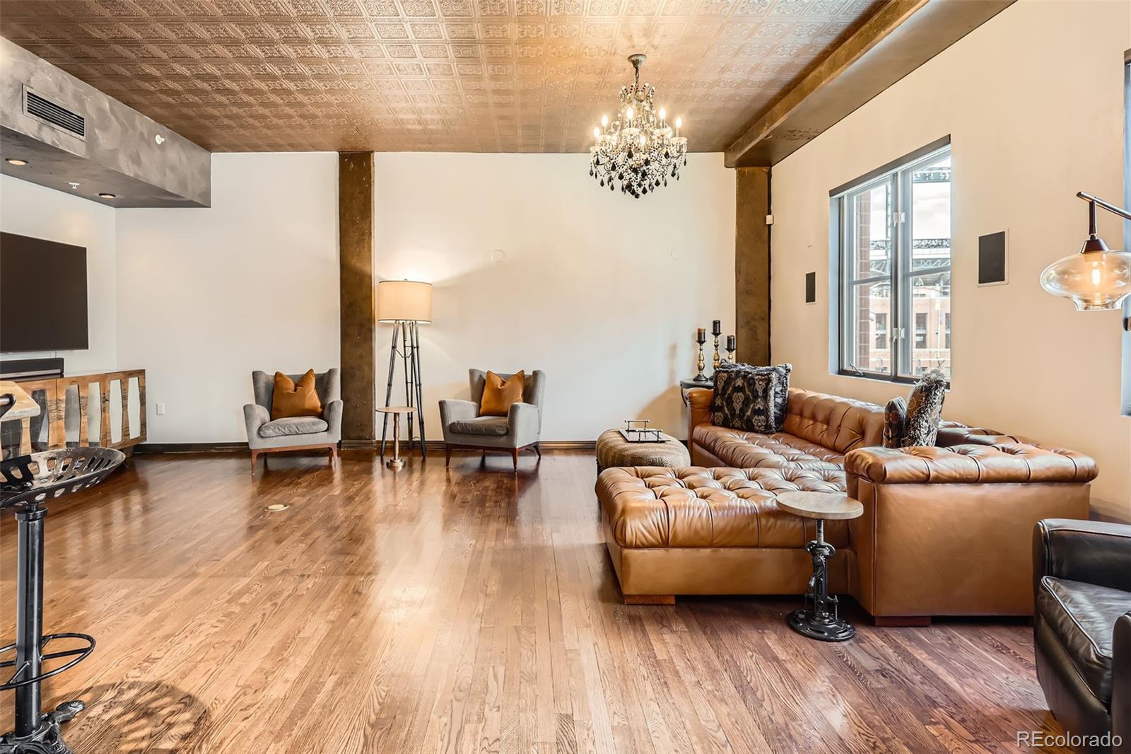 1735 19th Street, Unit 5B Denver, CO 80202 - Photo 9 of 50 a living room with furniture and a chandelier